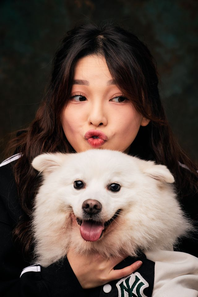 An owner pouting beside her white pomeranian